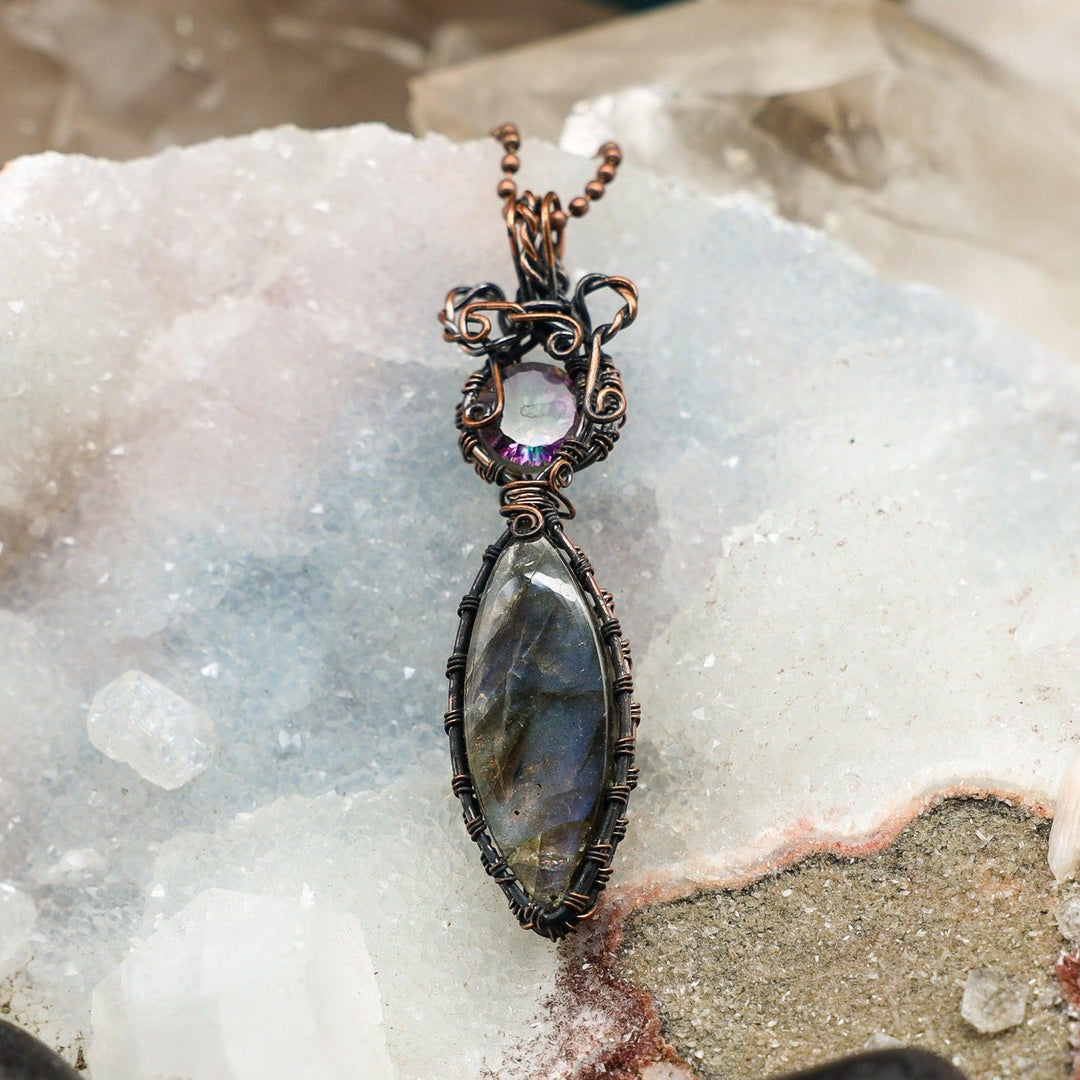Handcrafted copper wire wrap Labradorite Amethyst pendant, showcasing iridescent flash and violet hues for intuition and clarity.