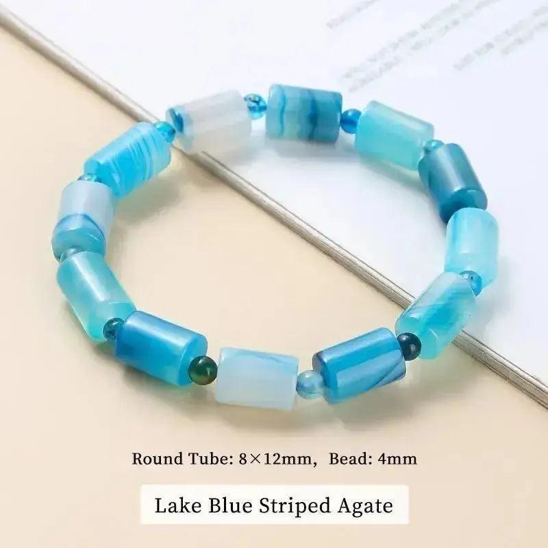 Lake Blue Striped Agate bracelet with polished tube beads, promoting calm energy and spiritual growth.