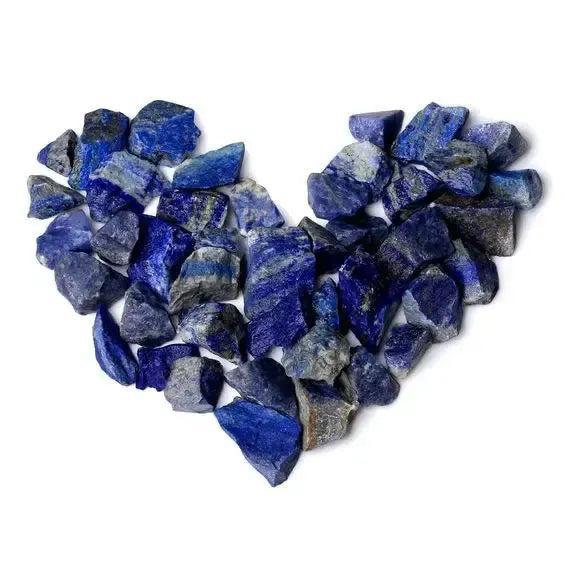 Raw Lapis Lazuli stones, deep blue with golden pyrite, arranged in a heart shape. Wisdom, truth, and inner vision.