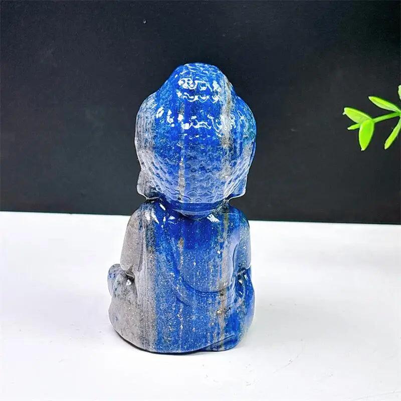 Hand-carved Lapis Lazuli Buddha statue with deep blue tones and gold pyrite flecks for meditation and chakra healing.