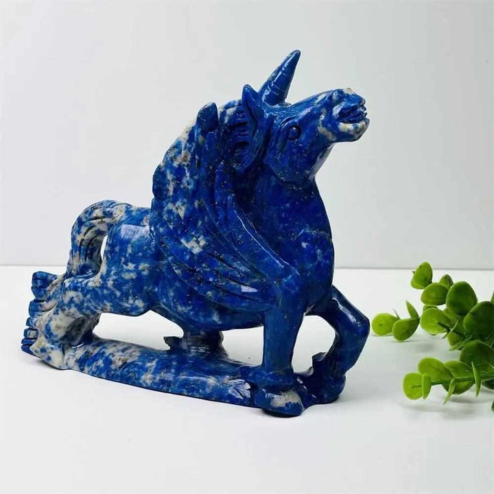 Polished lapis lazuli unicorn figurine, a handcrafted healing crystal carving for elegant home decor and energy balance.
