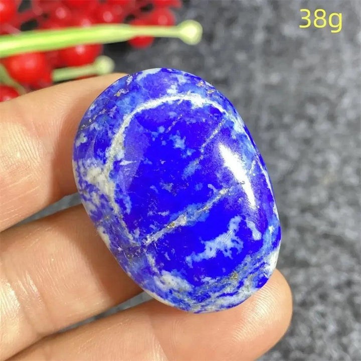 Hand-polished Lapis Lazuli crystal heart, deep royal blue with golden pyrite flecks, enhancing intuition and truth.