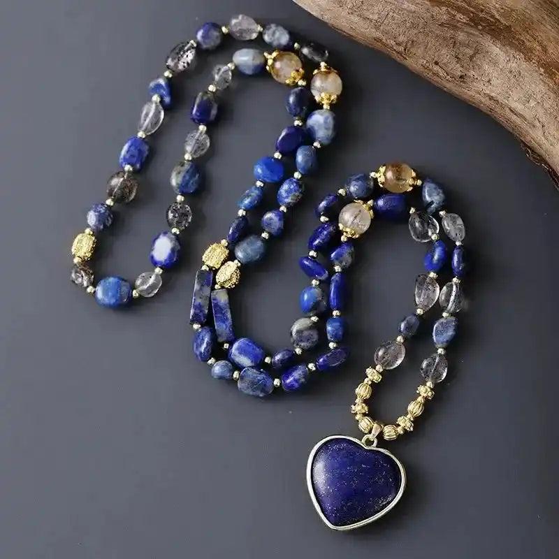 Deep blue Lapis Lazuli heart pendant lariat necklace with natural quartz beads, promoting wisdom and clarity.