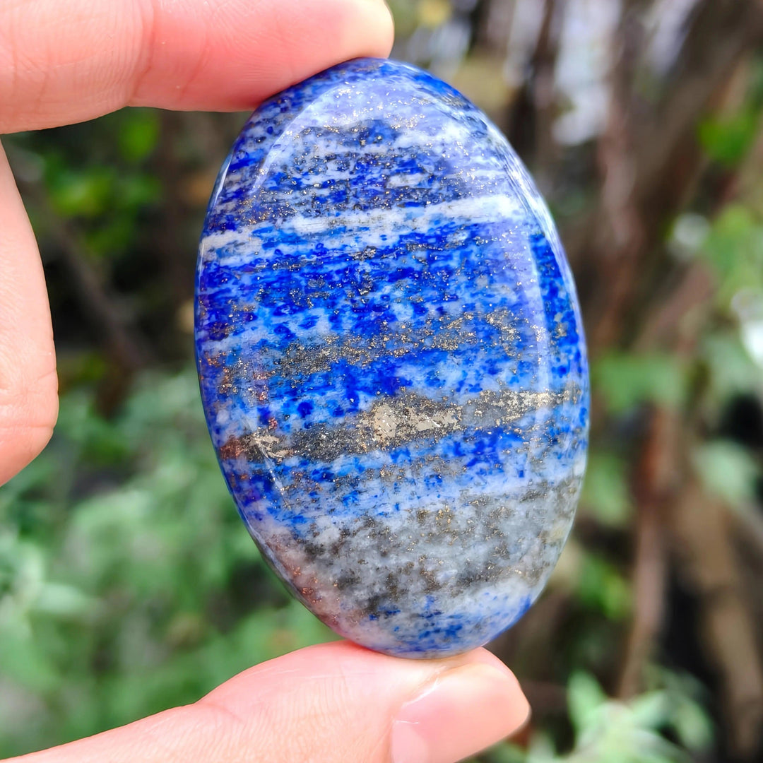 Lapis Lazuli Crystal Palm Stone with deep blue hues and golden pyrite flecks for Third Eye Chakra healing.
