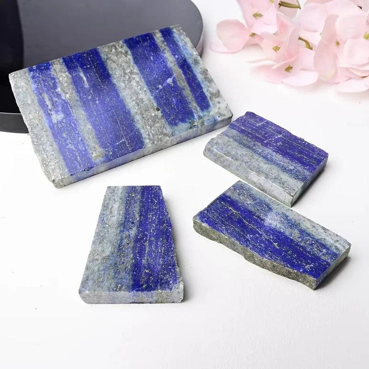 Polished royal blue Lapis Lazuli slabs with golden pyrite flecks for healing and elegant decor.