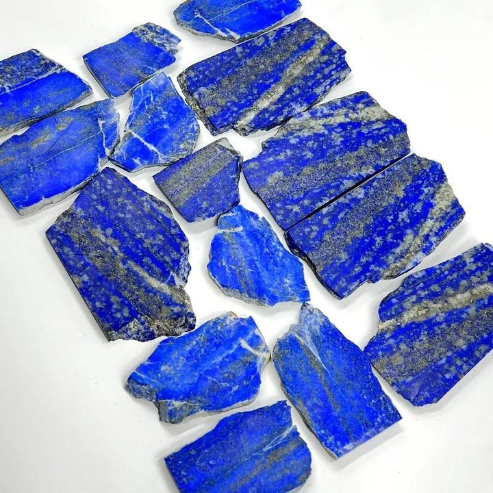Polished royal blue lapis lazuli slabs with golden pyrite flecks, a healing crystal for wisdom.