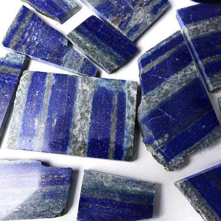 Polished royal blue Lapis Lazuli slabs with golden pyrite flecks and unique veins.