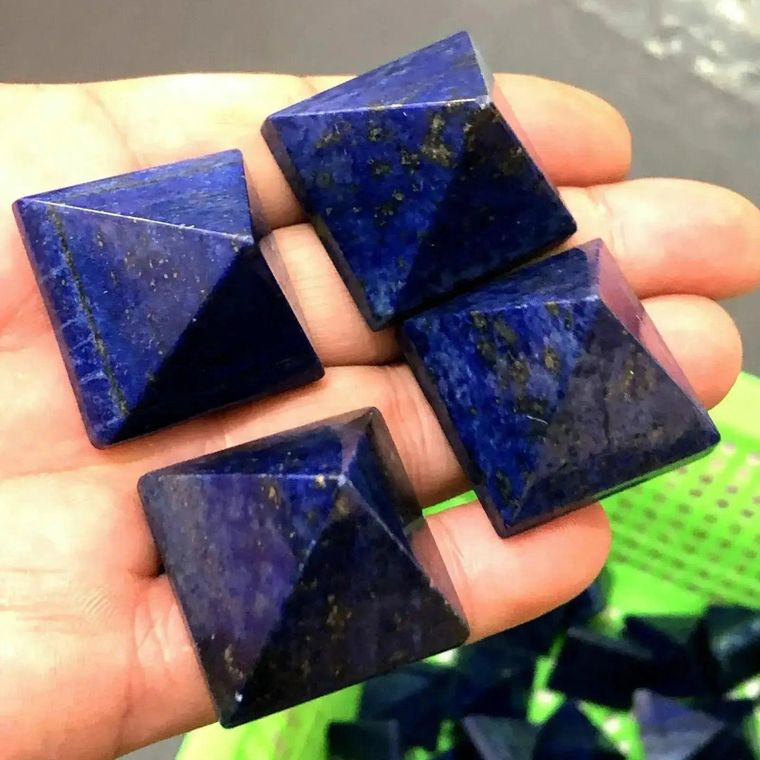 Natural Lapis Lazuli Crystal Pyramids: Deep royal blue AAA-grade pyramids with golden pyrite inclusions, held in a hand.