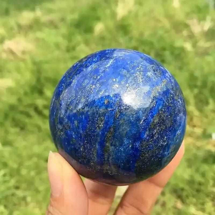 Polished Lapis Lazuli crystal sphere in deep royal blue with golden pyrite flecks for wisdom and intuition.