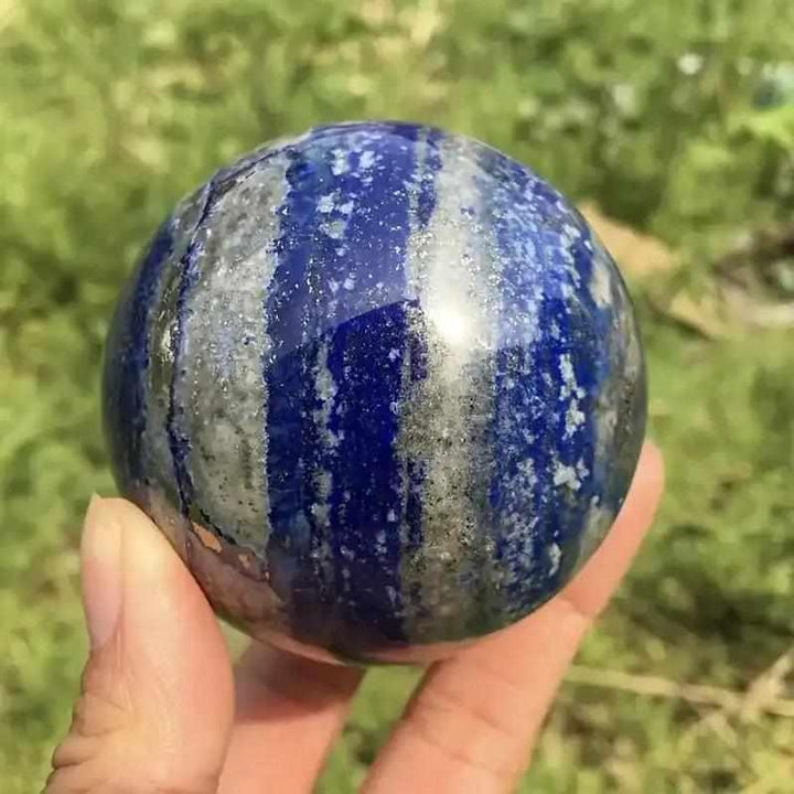 Polished Lapis Lazuli crystal sphere with deep blue hues, gold pyrite, and white calcite for wisdom and intuition.