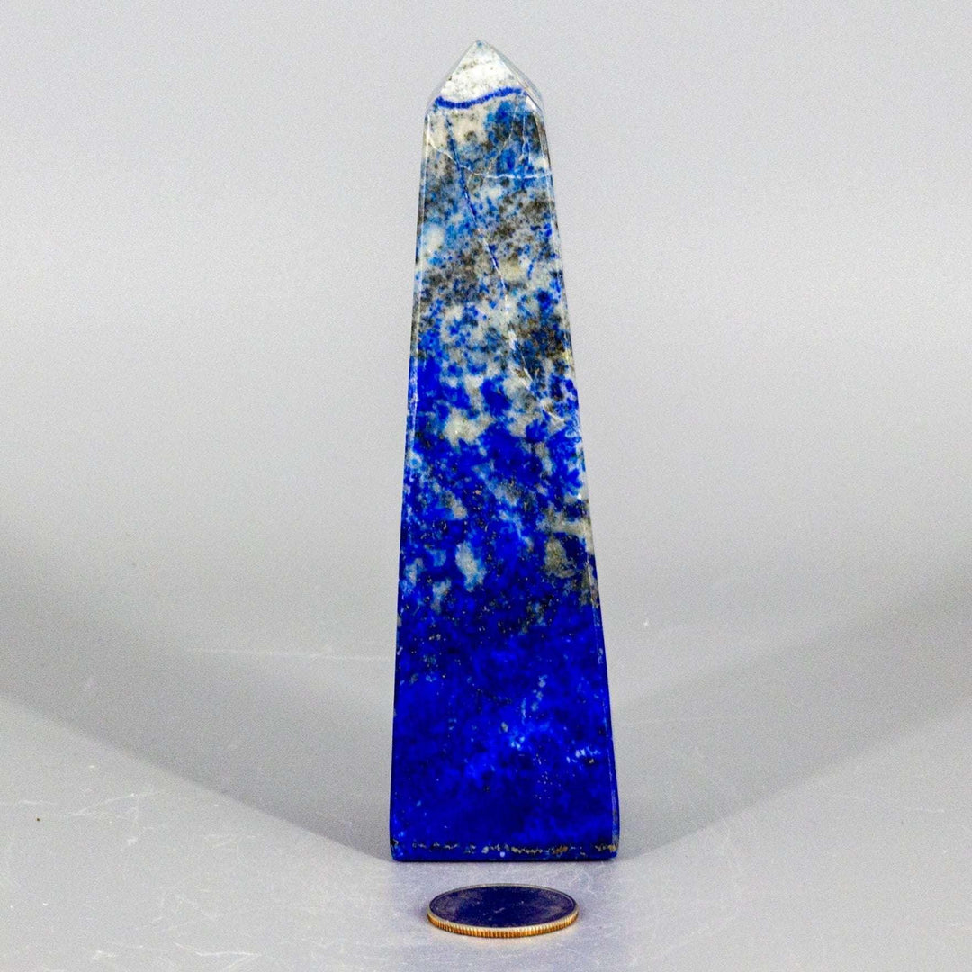 Large polished Lapis Lazuli Obelisk Tower, deep celestial blue with gold pyrite flecks, enhancing wisdom.