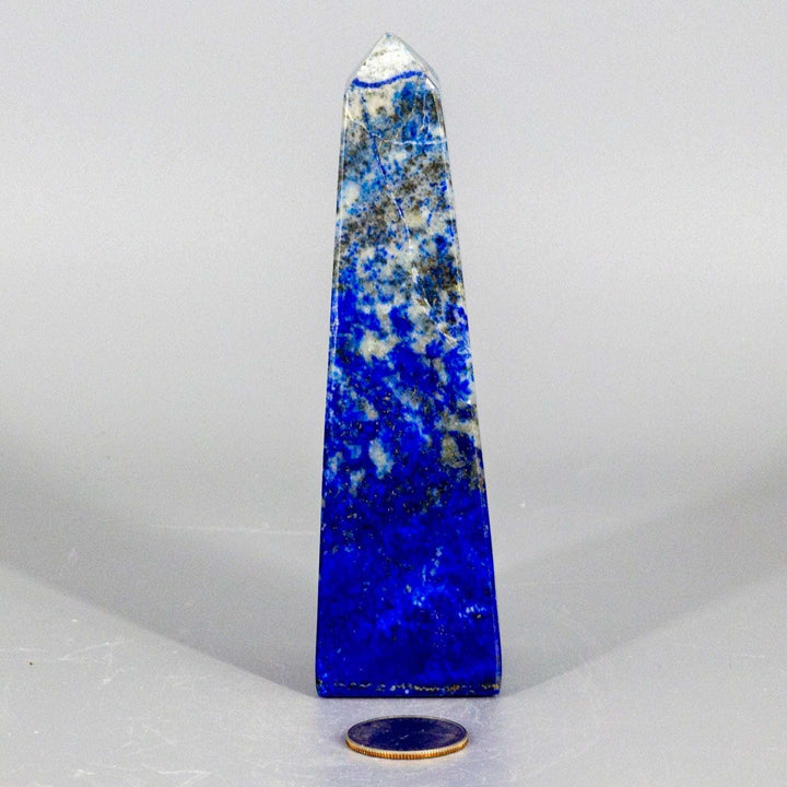 Large polished Lapis Lazuli Obelisk Tower, deep celestial blue with gold pyrite flecks, enhancing wisdom.