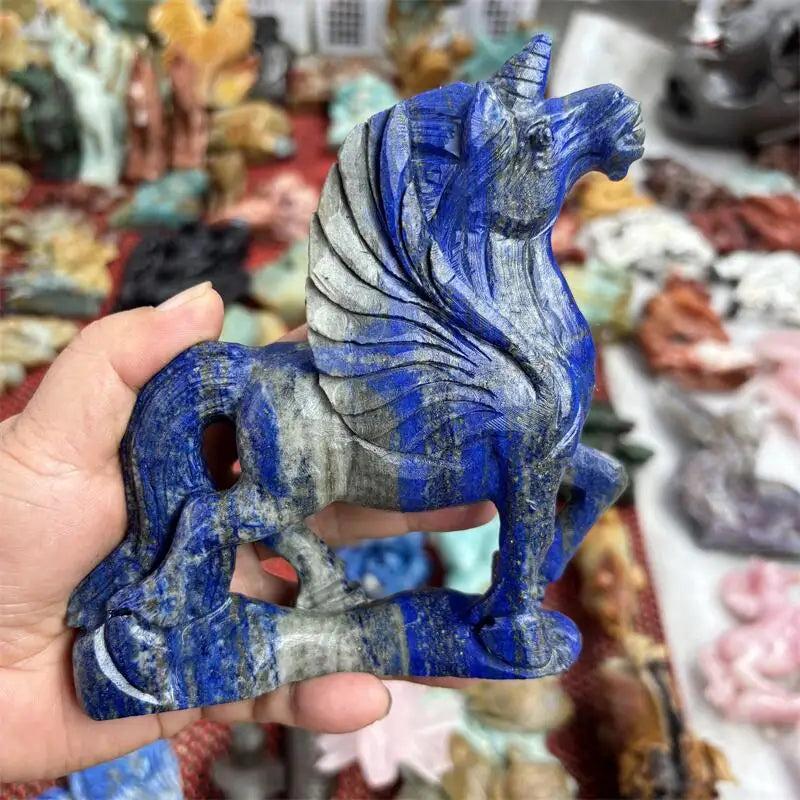 Hand-carved natural Lapis Lazuli unicorn figurine with blue and grey hues, ideal for chakra healing.
