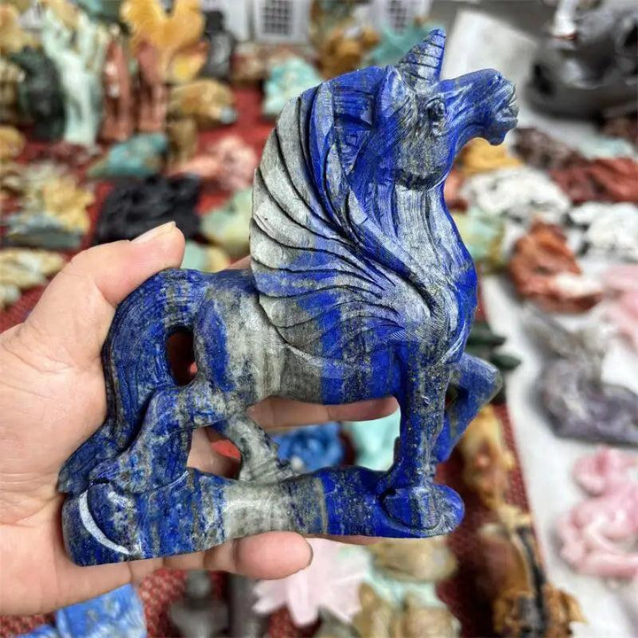 Hand-carved natural Lapis Lazuli unicorn statue, deep blue with grey veins, for chakra healing and decor.