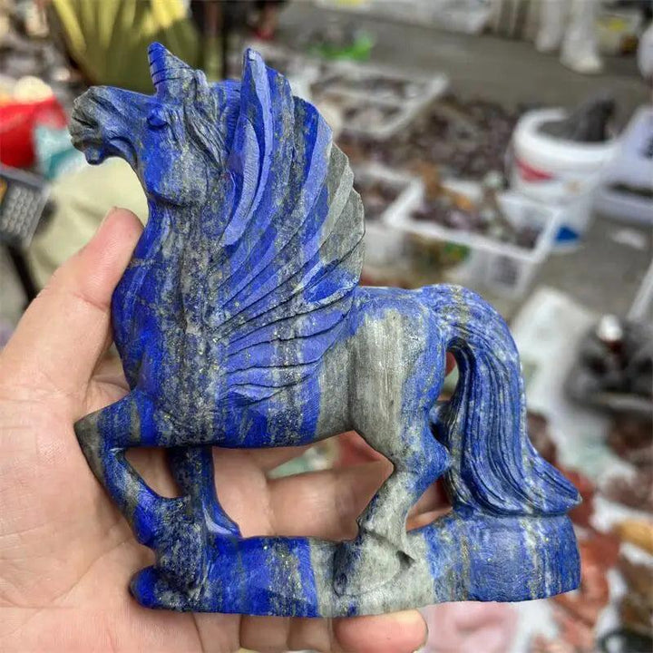 Hand-carved natural Lapis Lazuli unicorn figurine with deep blue and grey hues, ideal for healing and decor.