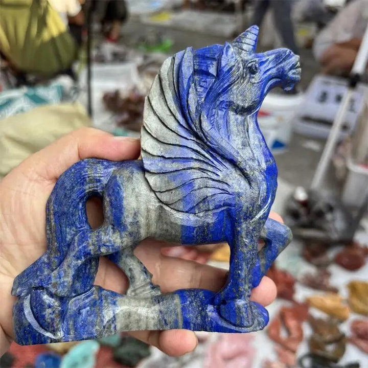 Hand-carved natural Lapis Lazuli unicorn statue, deep blue with grey veins, for reiki healing and decor.