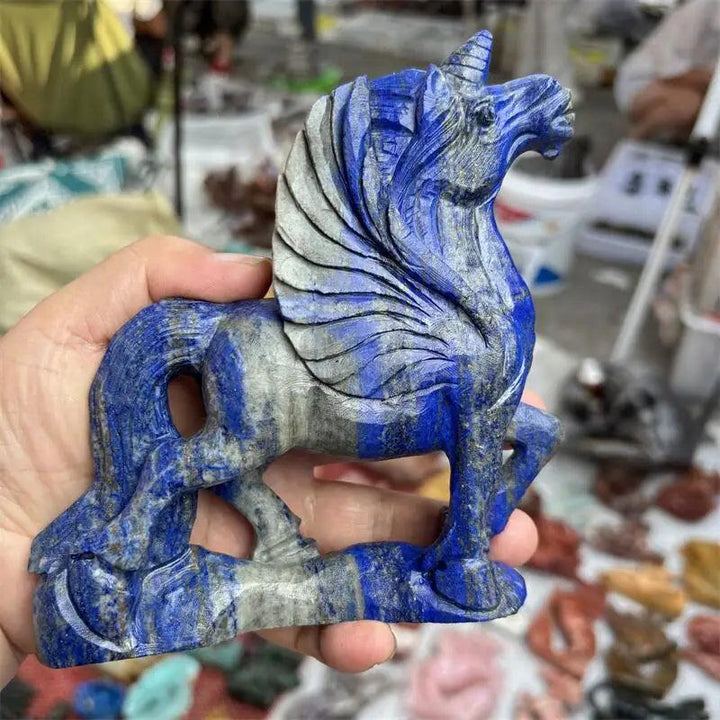 Hand-carved blue Lapis Lazuli unicorn statue with grey veins, a reiki healing gemstone figurine.