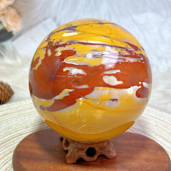 Large 2695g Mookaite sphere in red, yellow, and cream, perfect for grounding energy and display on its included stand.