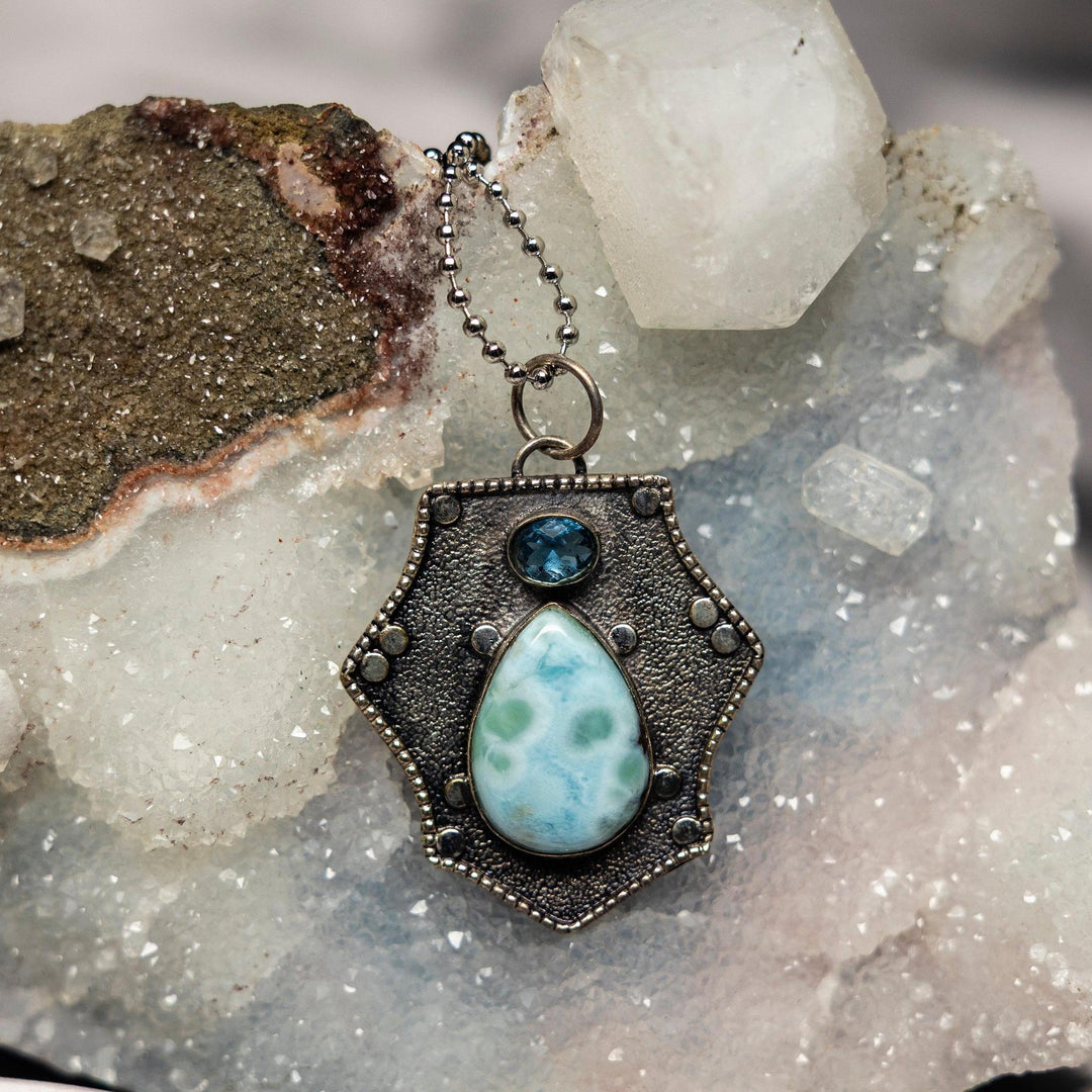 Larimar 925 Sterling Silver Pendant featuring a rare sky to ocean blue Larimar teardrop and blue topaz, promoting communication.