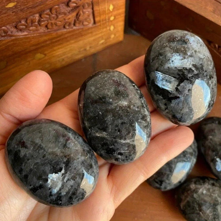 Polished Larvikite palm stones with dark grey tones and shimmering silver-blue flash for grounding and protection.