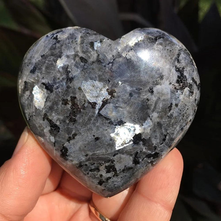 Polished Larvikite heart crystal with deep grey tones and a vibrant, grounding silver-blue flash for energy work.