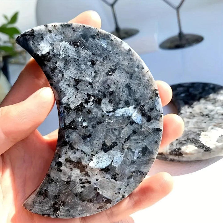 Polished Larvikite moon carving with dark grey tones and a striking silver-blue flash for grounding energy.