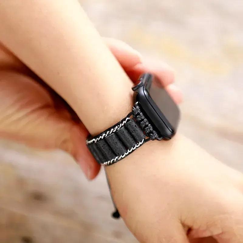 Handcrafted black lava stone and silver-accented Apple iWatch band by Crystal Destiny, worn on a wrist.