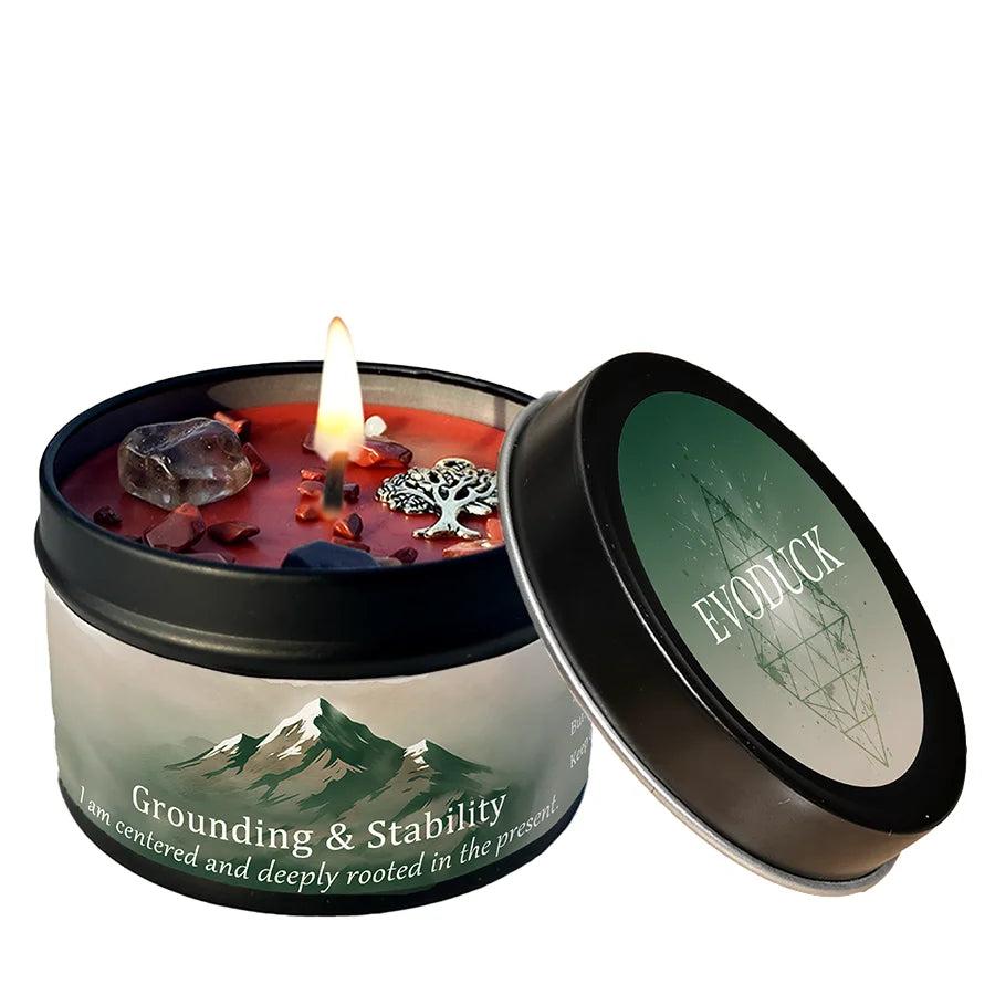 Lemon Peppermint Crystal Infused Intention Candle Tin for Grounding & Stability, featuring a lit red candle, smoky quartz, and a tree of life charm.