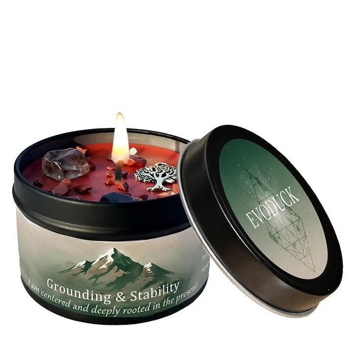 Lemon Peppermint Crystal Infused Intention Candle Tin for Grounding & Stability, featuring a lit red candle, smoky quartz, and a tree of life charm.