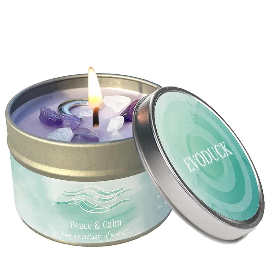 Lemon Peppermint "Peace & Calm" intention candle tin with amethyst and clear quartz crystals, burning brightly.