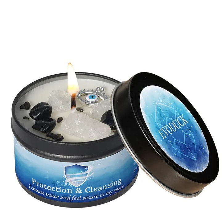 Lemon Peppermint Protection & Cleansing candle tin with black tourmaline, clear quartz, and an evil eye charm.