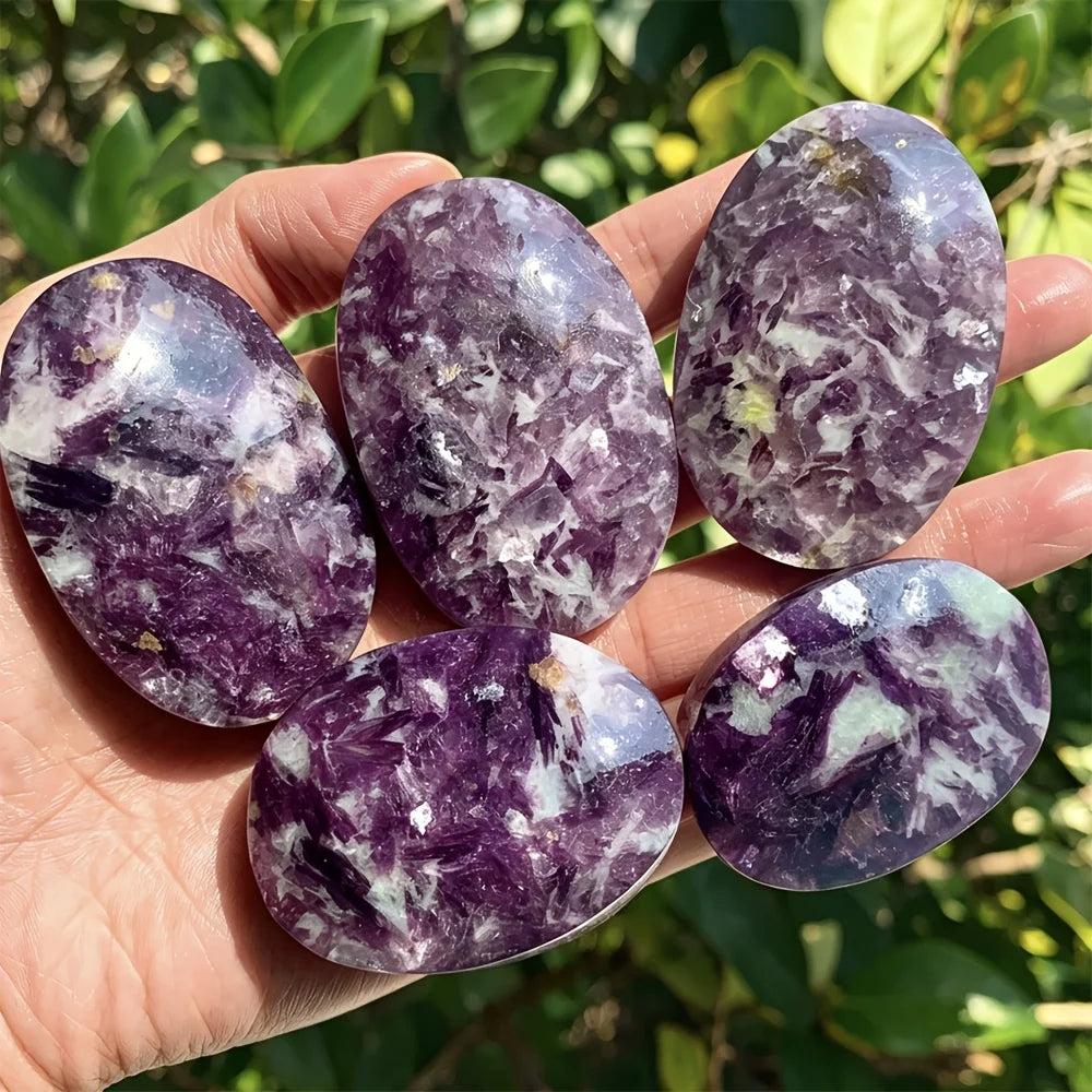 Polished violet-purple lepidolite palm stones with shimmering mica, perfect for healing and home decor.