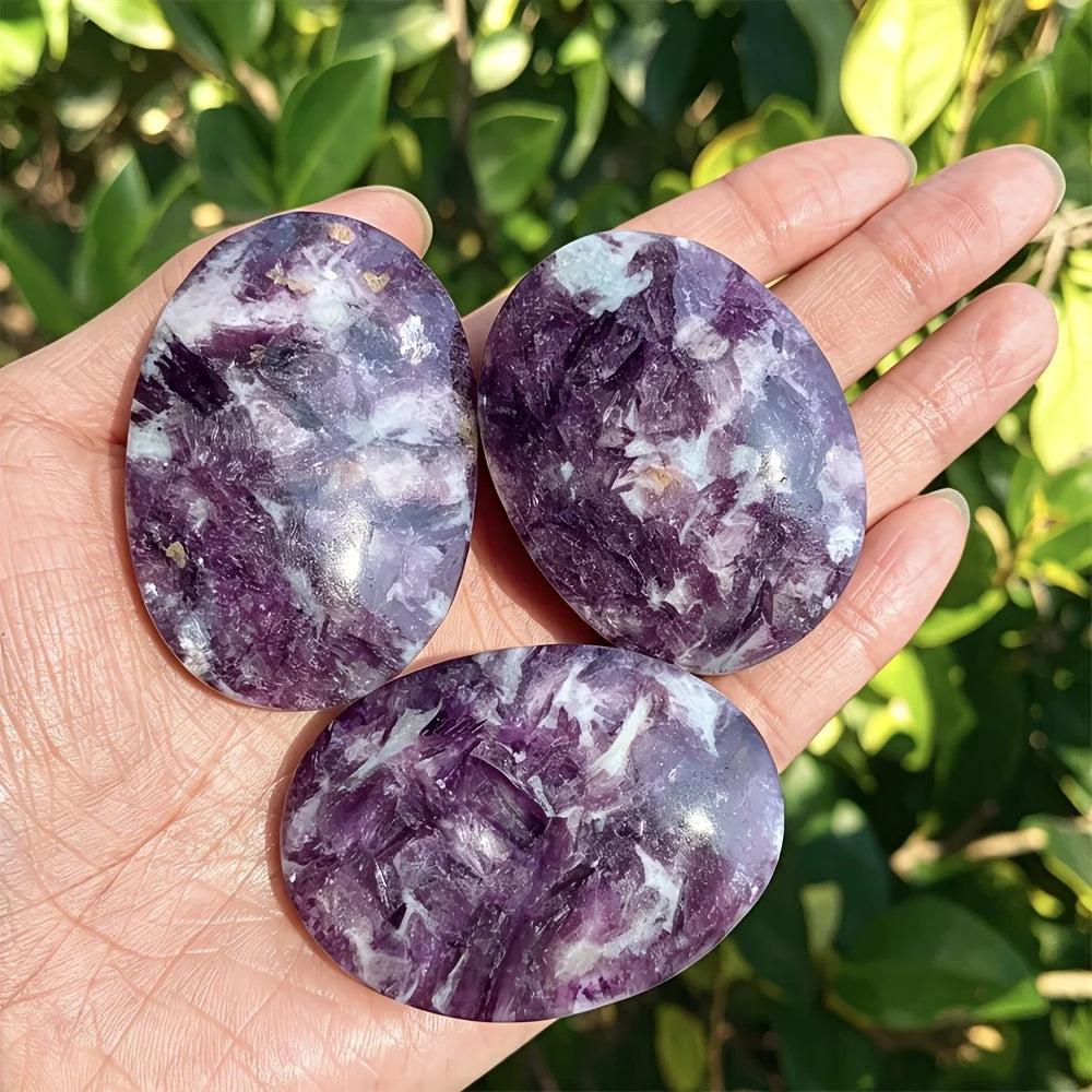 Polished violet-purple lepidolite palm stones with calming energy for home decor and healing.