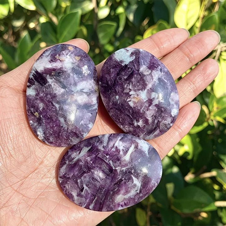 Polished violet-purple lepidolite palm stones with calming energy for home decor and healing.