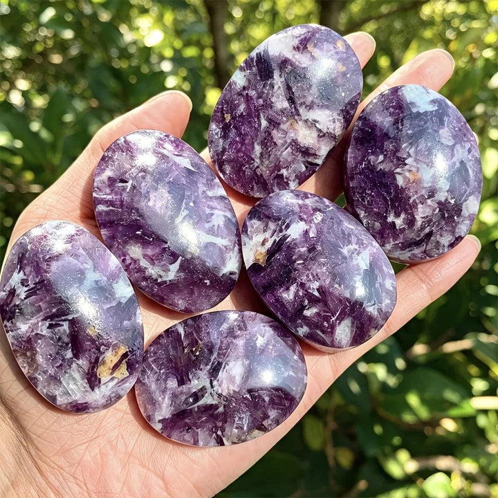 Polished violet-purple lepidolite palm stones with healing energy, perfect for home decor.