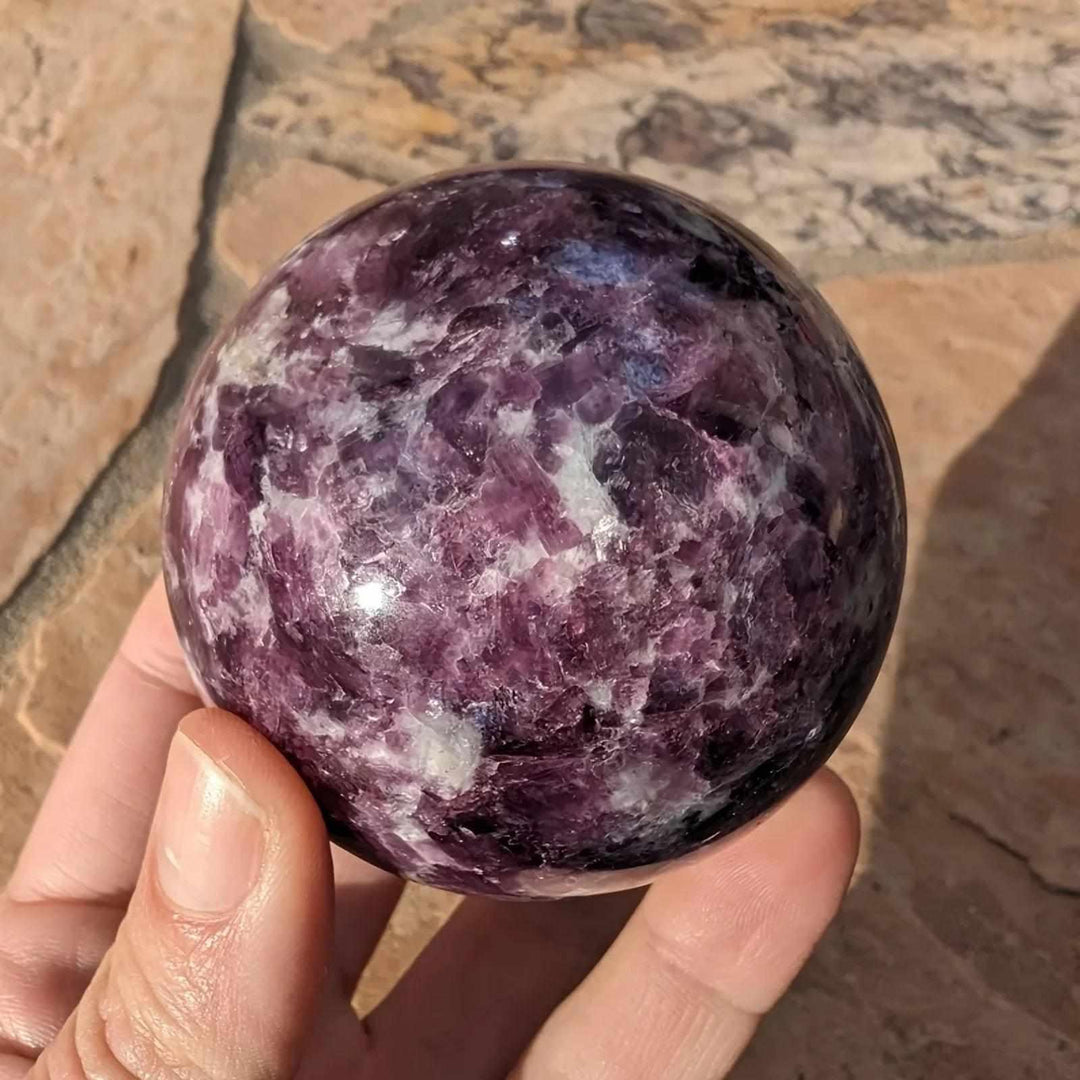 Polished natural Lepidolite crystal sphere with deep purple mica, perfect for calming boho home decor and energy healing.