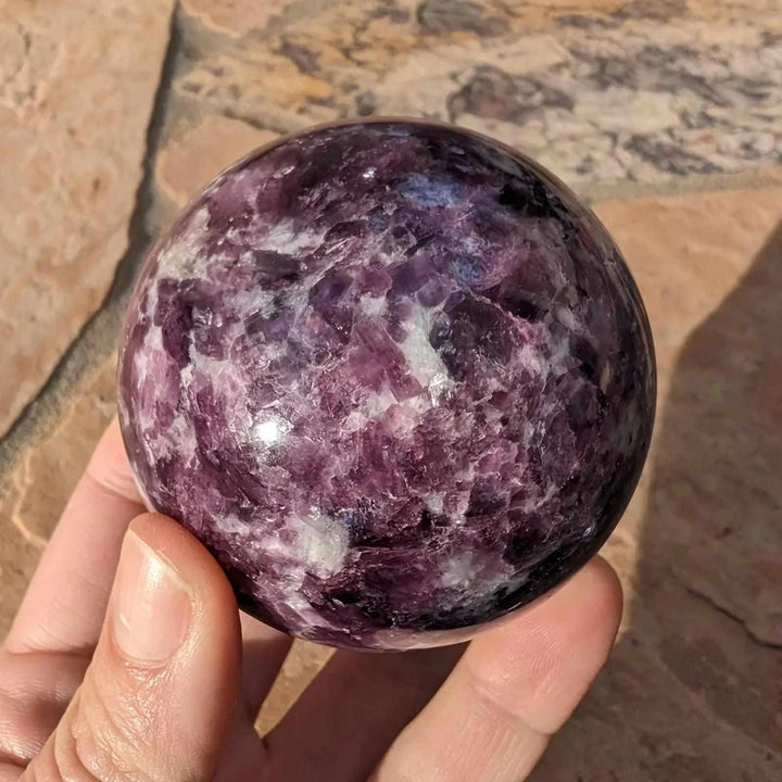 Polished natural Lepidolite crystal sphere with deep purple mica, perfect for calming boho home decor and energy healing.