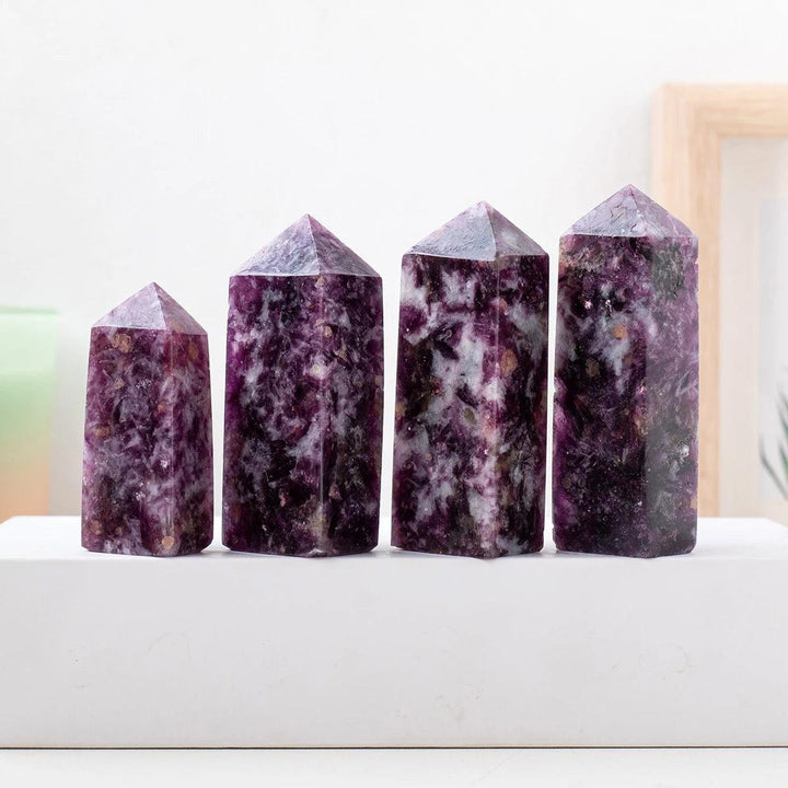 Four natural lepidolite crystal towers with deep purple hues and unique mineral patterns for healing and home decor.