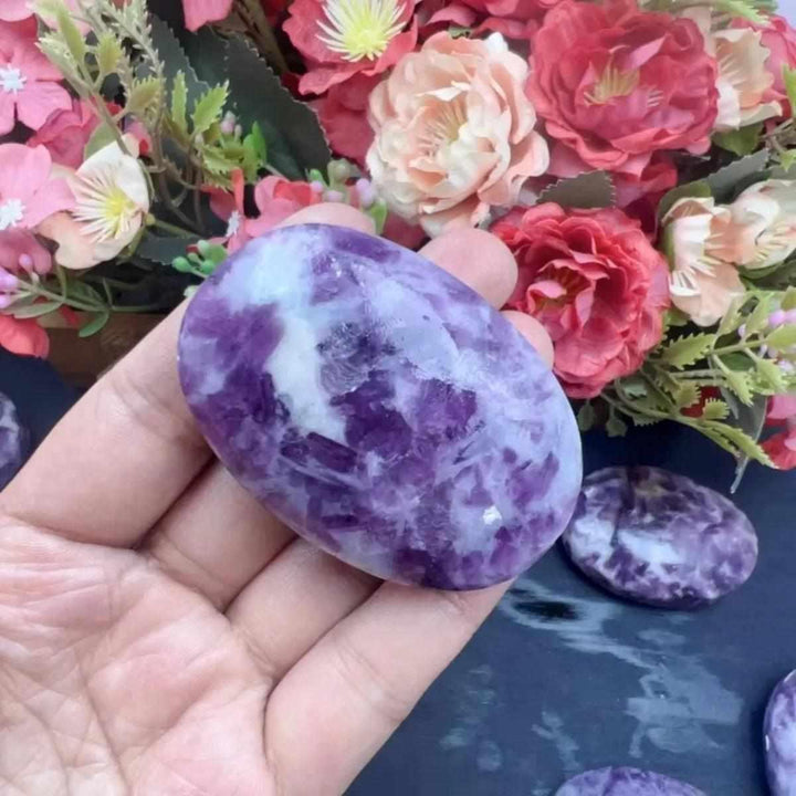 Smooth lavender Lepidolite palm stone with shimmering mica, perfect for calming meditation and emotional balance.
