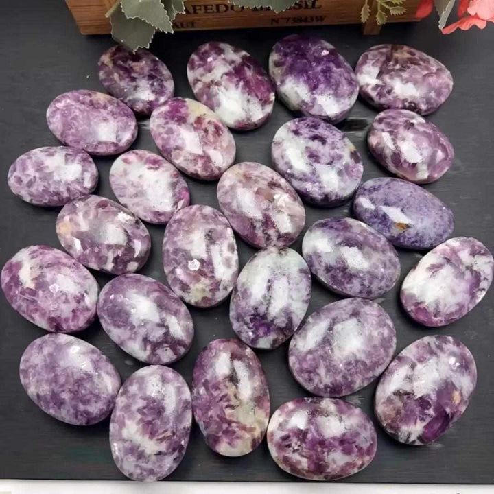 Smooth lavender Lepidolite palm stones with shimmering mica flecks, perfect for calming meditation and emotional balance.