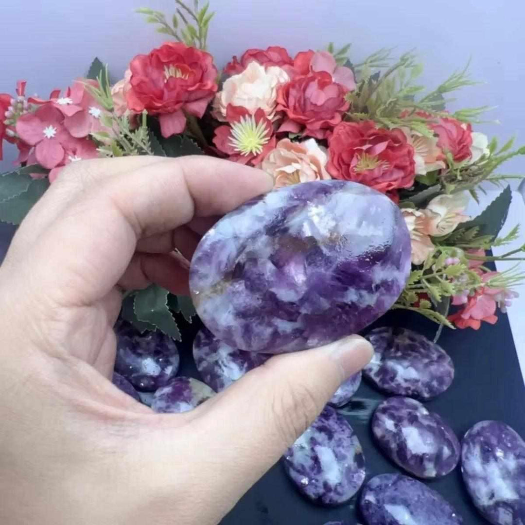 Smooth lavender Lepidolite palm stone with shimmering mica, perfect for calming meditation and emotional balance.