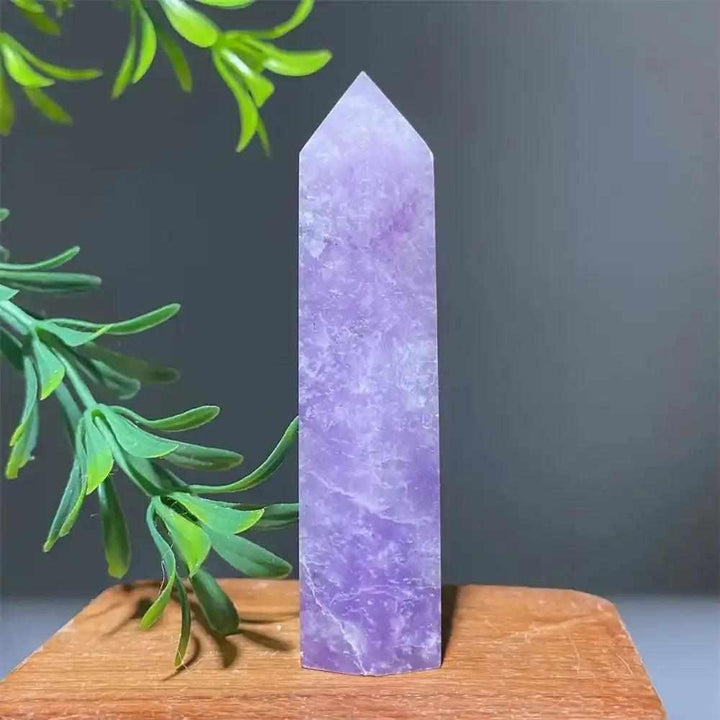 Polished lilac Lepidolite tower point with a sparkling finish, perfect for calming energy and chakra alignment.