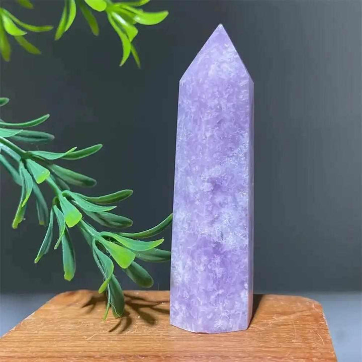 Polished lilac Lepidolite tower point with sparkling shimmer, perfect for calming energy and chakra balancing.