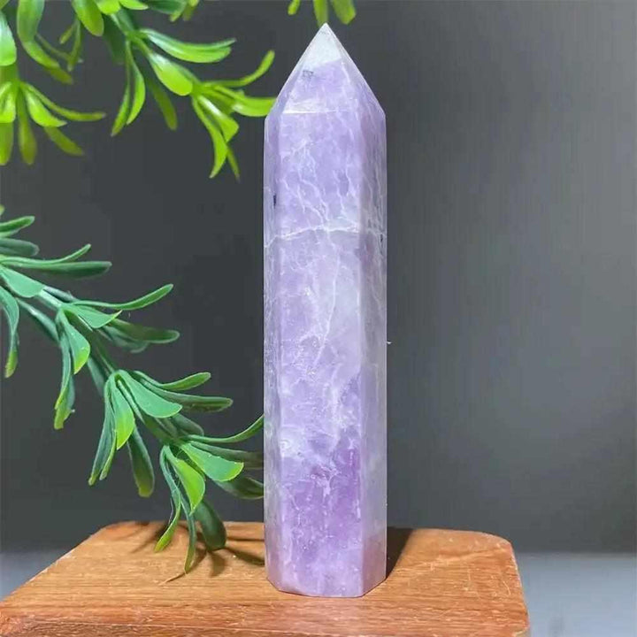 Polished lilac Lepidolite tower point with a sparkling finish, perfect for calming energy and chakra alignment.