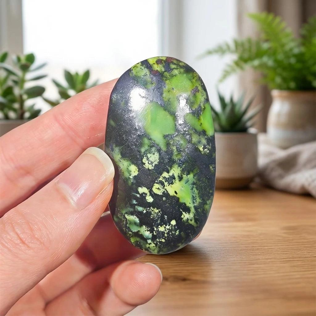Polished Lizardite palm stone with rich forest green hues and dark veining, perfect for grounding and heart healing.