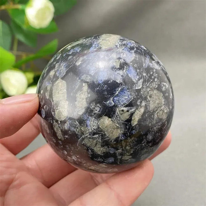Rare Llanite Crystal Sphere: Hand-polished, blue, pink, gray tones with sparkling inclusions for empowerment and balance.