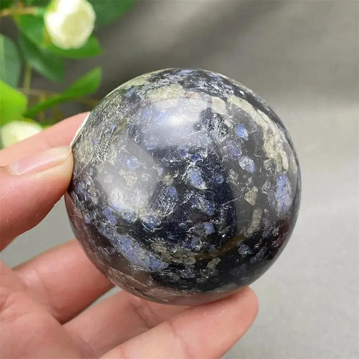 Llanite Crystal Sphere: Rare, hand-polished sphere with blue, pink, and gray tones, promoting empowerment and balance.