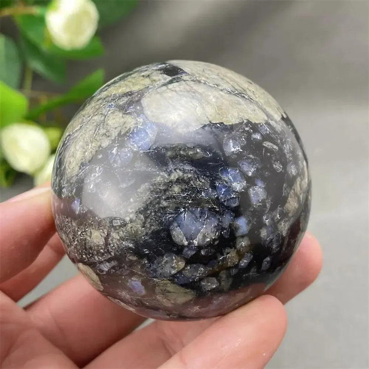 Llanite Crystal Sphere: Rare, hand-polished sphere with captivating blue, pink, and gray tones, promoting empowerment.