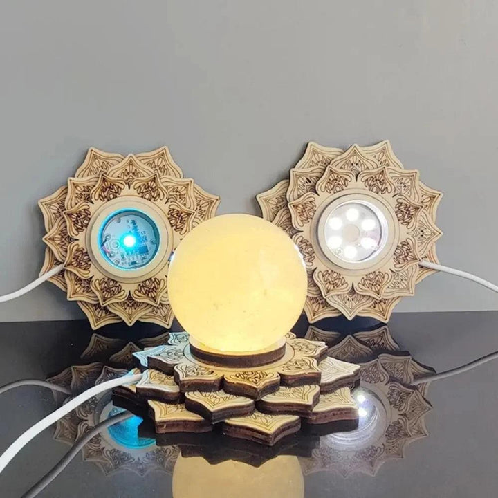 Wooden lotus LED crystal ball stand with a glowing yellow sphere, flanked by two unlit bases.