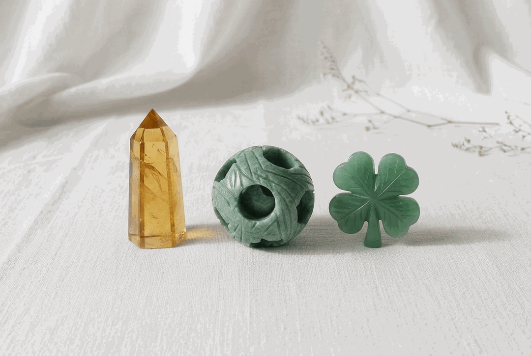 Luck & Good Fortune Crystal Bundle featuring a golden citrine point, carved jade sphere, and green aventurine clover.